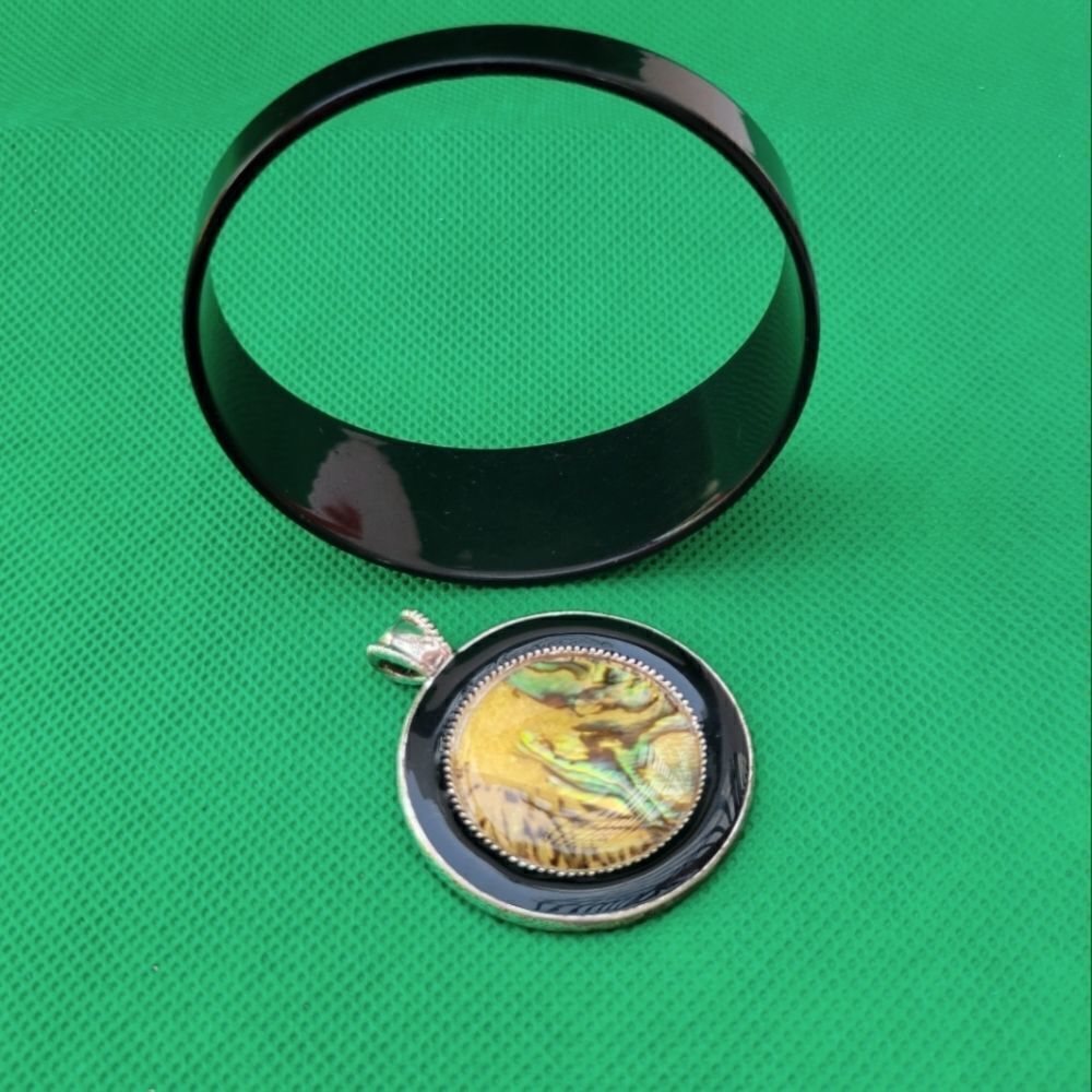 Vintage Monet Paint Spill Pendant and black bracelet.